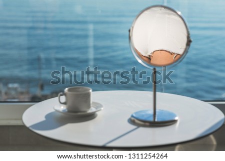 Reflection of female buttocks in a white denim shorts in a table mirror. Concept of lifestyle