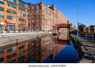 Reflection of Footbridge and warehouses  in Murray Mills Redhill Street Ancoats Manchester UK - Powered by Shutterstock