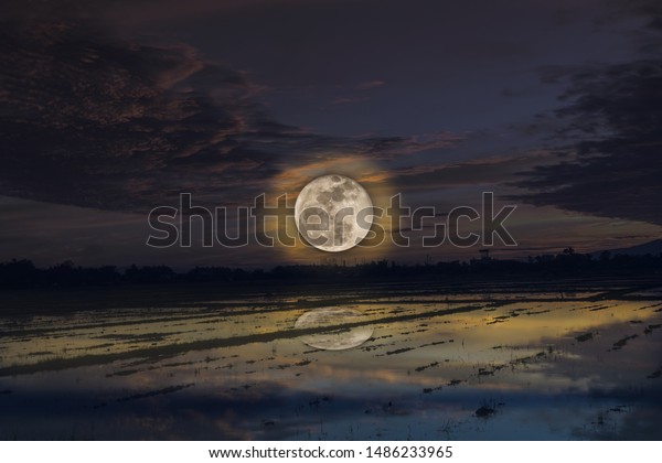 A\
reflection of full moon on water , nature background\
