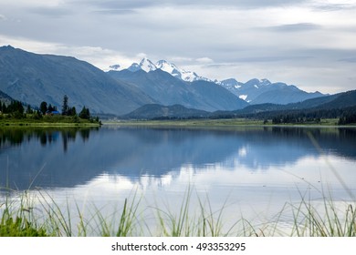 Reflection of hight mountain in Yazevoe mountain lake in National park. Altay mountain. Kazakhstan