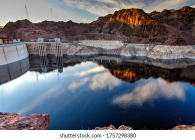 Reflection Of The Hoover Dam And Surrounding Mountains On The Surface Of Lake Mead On The Arizona And Nevada Border. The Hoover Dam Is The Largest In The United States And A Popular Tourist Attraction