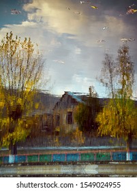 reflection of house in puddle .