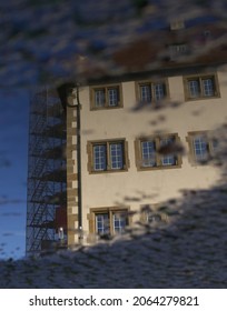 reflection of a house in a puddle
