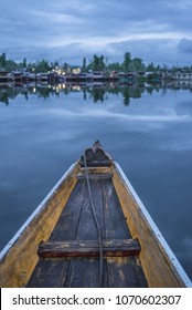 Reflection of houseboat at Dal Lake, Srinagar, Kashmir, India during sunrise. Sightseeing with shikara ride, a traditonal boat at Dal Lake. Image may contains a bit noise due to low light environment