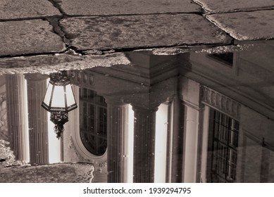 Reflection of a Lantern in a Puddle at Night