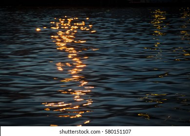 The Reflection Of Light On Water At Night.