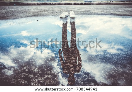 Reflection of man standing near puddle, Style is a reflection of your attitude and your personality,Education begins the gentleman, but reading, good company and reflection must finish him. Сток-фото © 