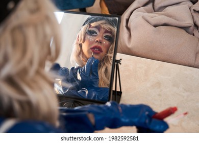 Reflection at the mirror of the extravagant drag queen with creative makeup - Shutterstock ID 1982592581
