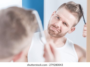 Reflection In The Mirror Of Handsome Man Styling Hair