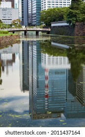 Reflection Of The Modern Skyscrapers Of Marunouchi District In The Hirakawa Moat Around Old Edo Castle. Tokyo. Japan