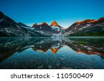 Reflection of mount Assiniboine on Magog lake at sunrise, Alberta, Canada