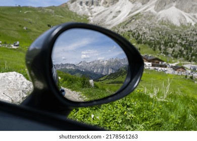 Reflection of the mountain in the car mirror
