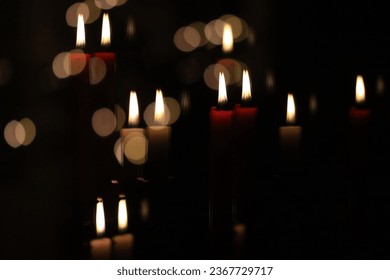 Reflection of multiple red and white candles on a black background with golden bokeh dots. - Powered by Shutterstock