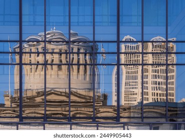 Reflection of the Ohio state Capitol building in the windows of an office building across the street in Columbus, OH