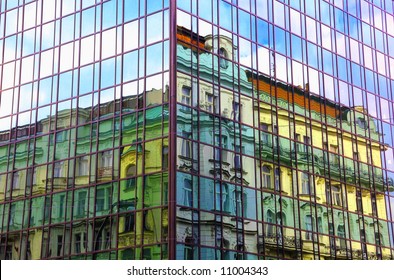Reflection Of Old Baroque Building In  Windows Of New Building