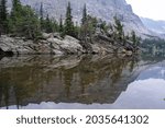 Reflection on a calm, still Loch Vale lake, a remote alpine lake in Rocky Mountain National Park Colorado