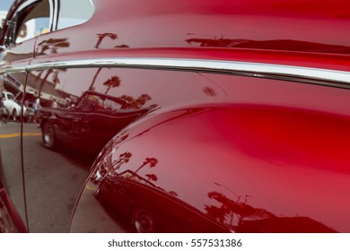 The reflection on the driver's side of a classic car in southern California.