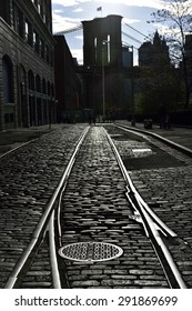 Reflection on railway at cobblestone street in DUMBO, leading to the Brooklyn Bridge, New York City, New York
