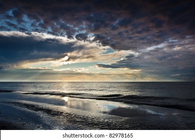 Reflection On The Sand Over Dynamic Sky