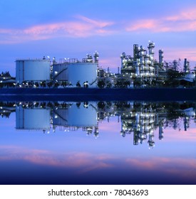 Reflection of petrochemical industry on sunset colorful sky