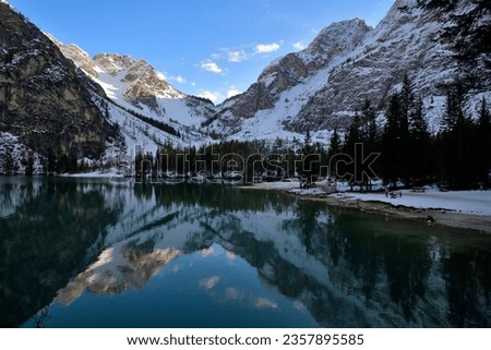 Reflection in The Pragser Wildsee, A Mountain Lake in The Dolomites, High Mountains and a Beautiful Lake, In the Natural Park of the Dolomites, Wintry mountain landscape at the famous Pragser Wildsee,