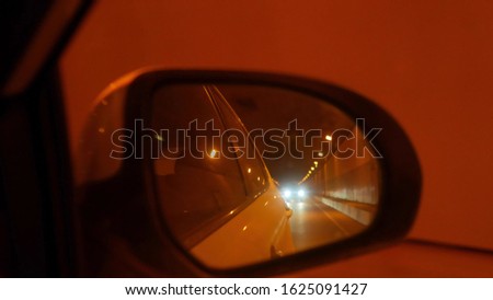 the reflection in the rear view mirror while driving. the illumination in the tunnel.