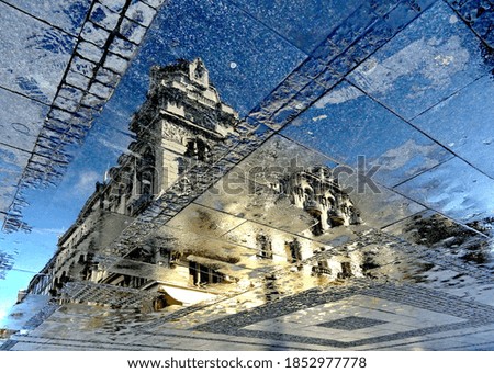 Reflection residential building  in puddle