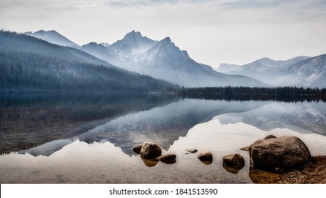 Reflection of Sawtooth Mountains on Red Fish Lake on foggy morning, Stanley, Idaho. - Shutterstock ID 1841513590
