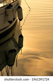 The Reflection Of Ship Ballast Weight Bags On The Golden Water