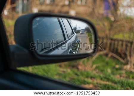 reflection in the side mirror of the car