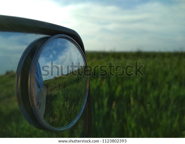 Reflection in the side mirror of the car, display\
of the field in the mirror,\
nature