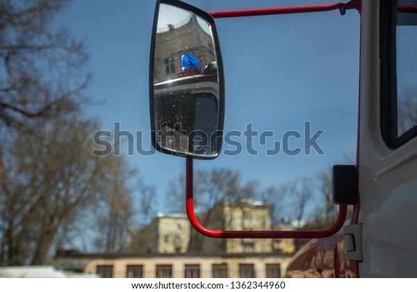 reflection in the side mirror of the rear view\
of the truck while driving on the highway, safety review of the\
situation on the road in freight\
transport