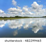 Reflection of sky and clouds causes you to see double, as the surface of the Yahara River serves as a mirror for the scenery, on the Yahara River Trail in Wisconsin.