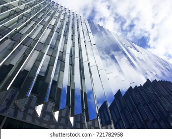 The reflection of the sky in the mirrored Windows of a skyscraper