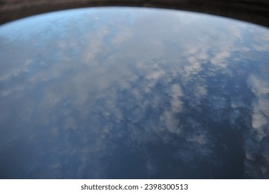 The reflection of the sky on the surface of the water is like a view of the earth from space