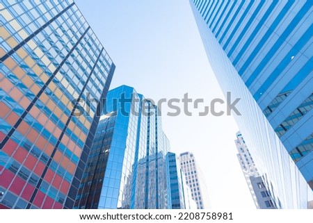 Reflection of skyscraper and cooperate office buildings on glass walls in downtown Oklahoma City, USA clear blue sky. Low angle view façade exterior of modern high rise towers
