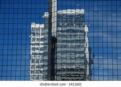 Reflection of a skyscraper in glass side of another highrise building