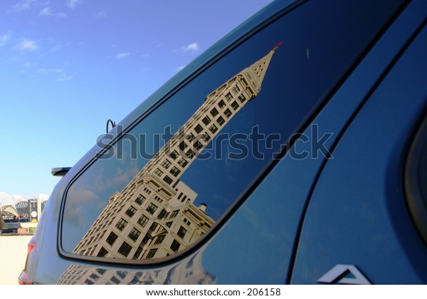 reflection of\
smith tower (seattle) in car\
window