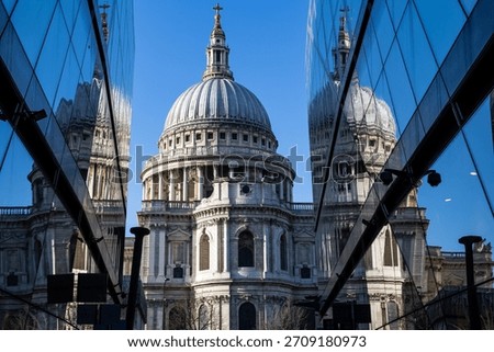 Reflection of St Pauls Cathedral in the windows of two modern office buildings in London
