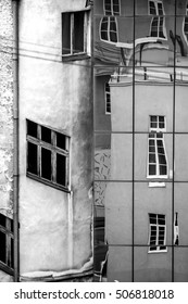 reflection of stone facade on modern glass facade. black and white photo