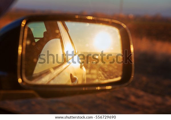 reflection of sun in car\
mirror