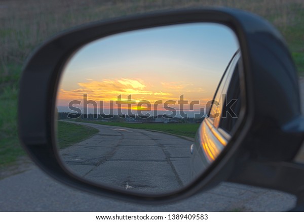 Reflection of the sunset in the car\
mirror. Bright reflection of the sunset in the car\
mirror