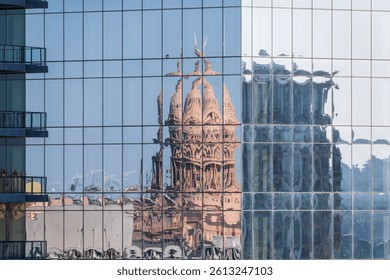 Reflection of the Texas State Capitol dome in the multiple glass windows of modern skyscraper in Austin