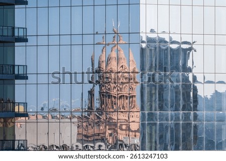 Reflection of the Texas State Capitol dome in the multiple glass windows of modern skyscraper in Austin