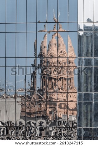 Reflection of the Texas State Capitol dome in the multiple glass windows of modern skyscraper in Austin