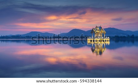 Reflection of thai pavilion at Khao Tao reservoir in sunset, Hua Hin, Thailand