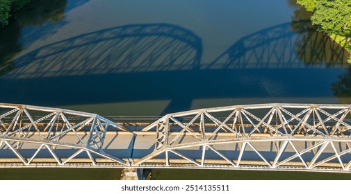 The reflection of the Tidioute Bridge on the Allegheny River as seen from above in Tidioute, Pennsylvania, USA on a sunny summer day - Powered by Shutterstock