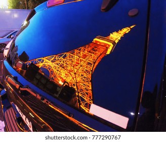 Reflection Of  Tokyo Tower  In  Car  Window.   Tower Look Like  Eifel  Tower And Have  Orange   Color.