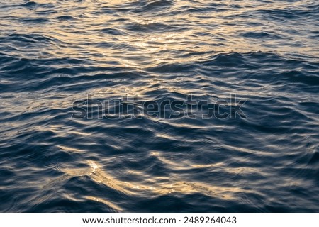 Reflection of vibrant sunset in the calm waters of the ocean