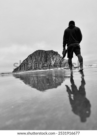 Reflection walk on the beach. Morro Rock in the background. Picture taken on September 21, 2024 by Andrea Sanchez at Morro Beach.